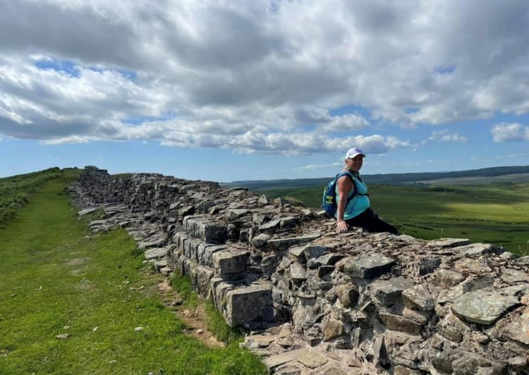 Michele sitting on Hadrian's wall